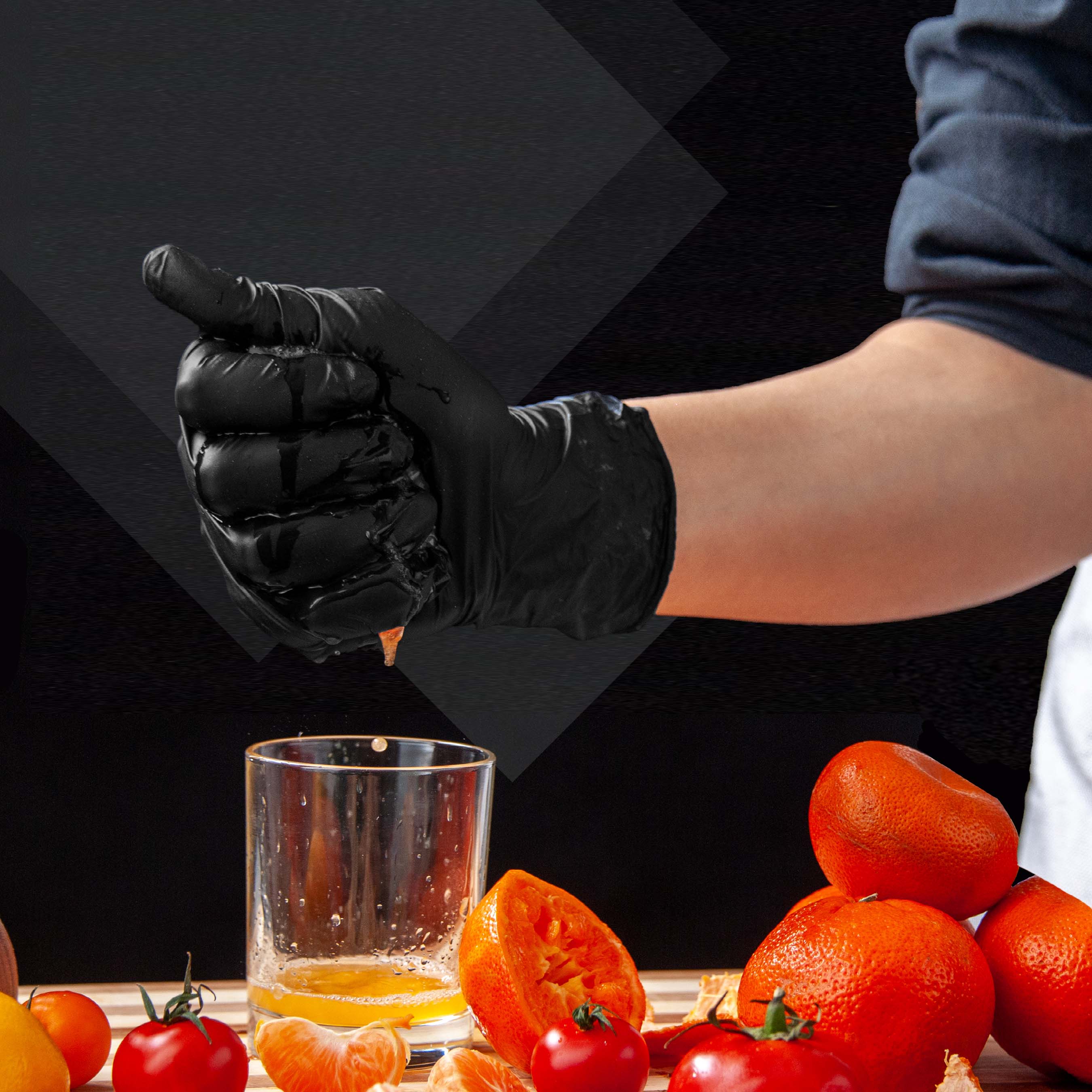Hand wearing black MAMISON nitrile gloves squeezing fresh orange juice, durable powder-free latex-free disposable gloves ideal for food preparation and kitchen use.